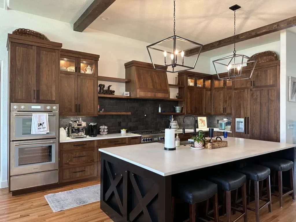 Kitchen with dark wood cabinetry and ceiling beams, from Rainier Construction project photography