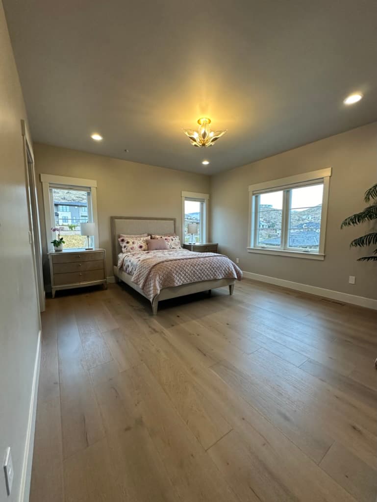 Bedroom with trimmed windows and a view of neighboring hills