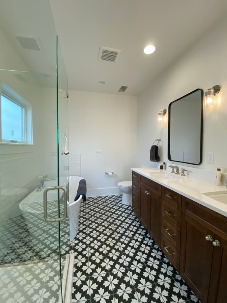 Bathroom with a glass shower, a freestanding tub, and a dark wood vanity